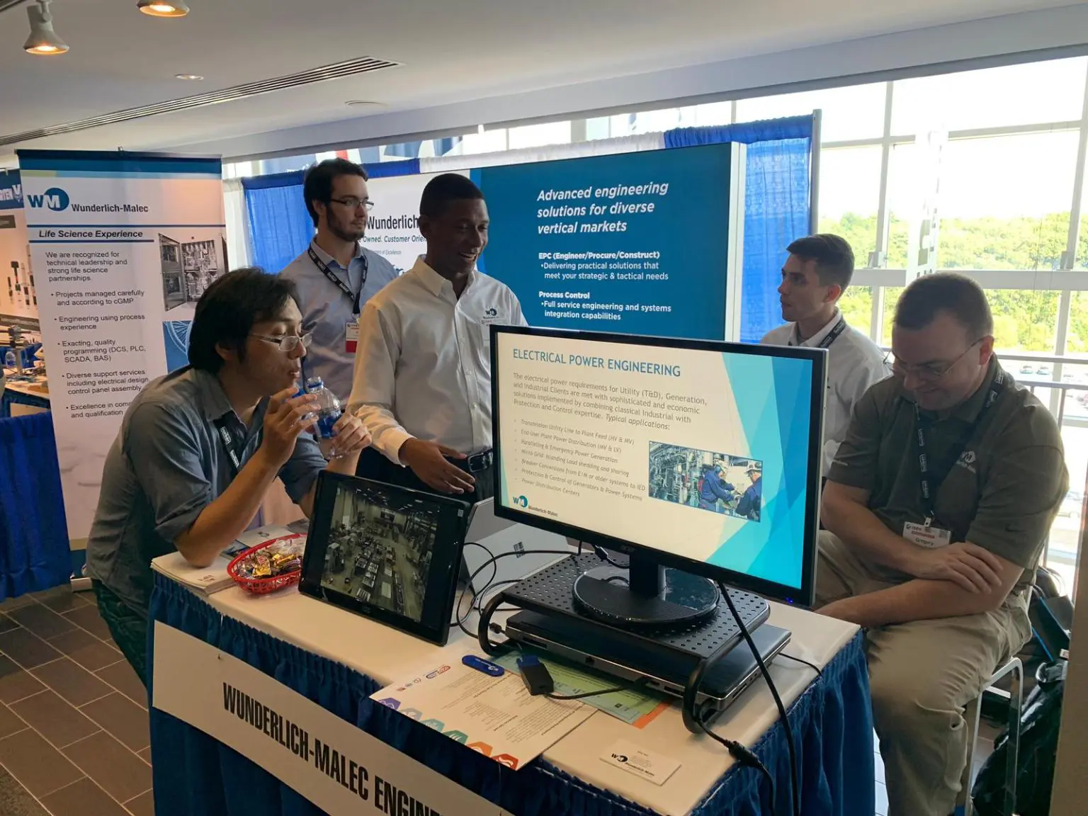 Wunderlich-Malec employees working at a booth during the Boston Trade Show.