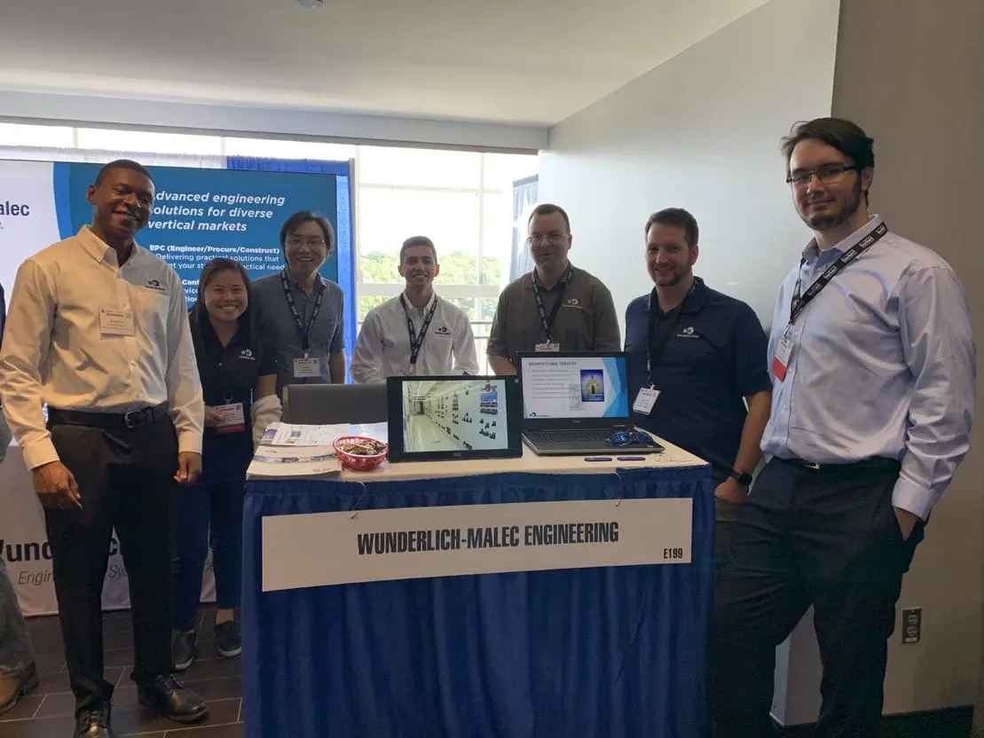 Wunderlich-Malec employees working at a booth during the Boston Trade Show.