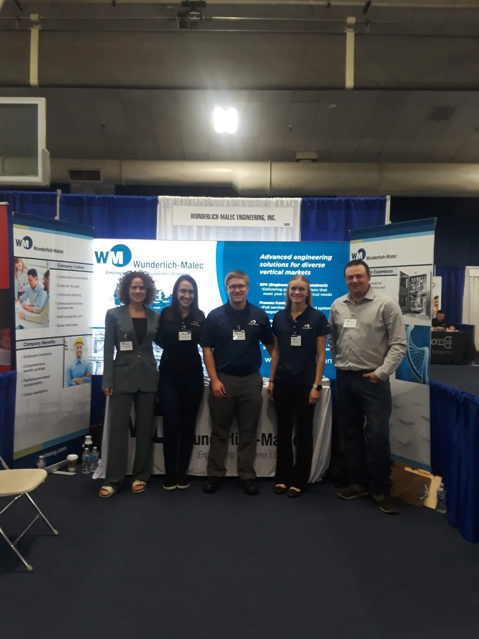 Wunderlich-Malec employees working at a booth.