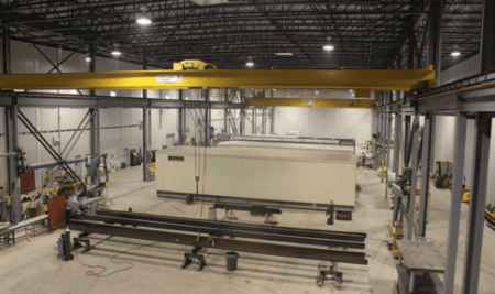 Assembly Line Process of Enclosure to work cells using 5 and 30 Ton Bridge Cranes.