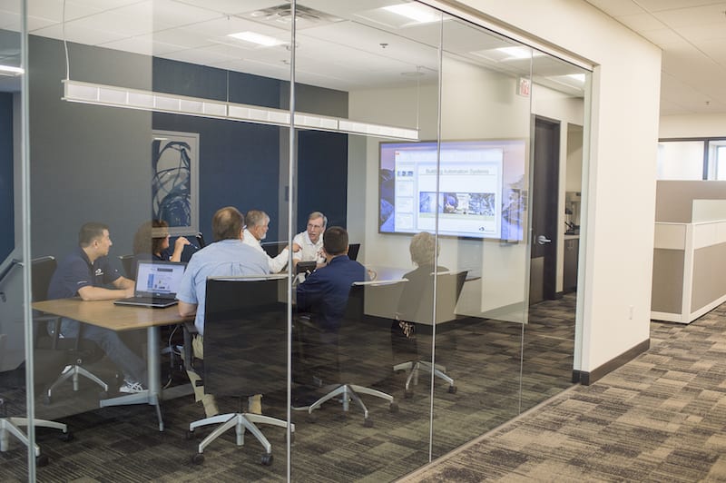 Employees having a team meeting around a conference table.