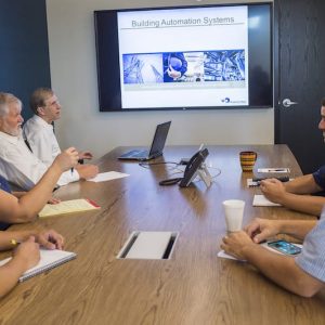 Employees having a team meeting around a conference table.