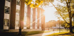 Sun shining the exterior of a campus building.