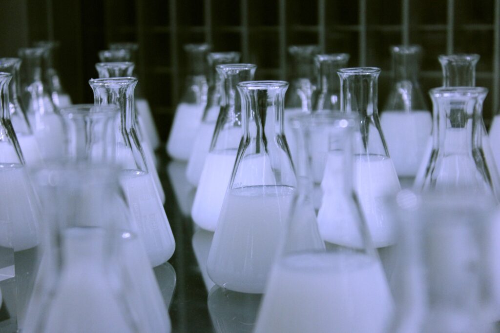 Flasks containing white liquid.