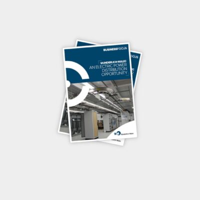 A stack of magazines with the top one titled "An Electric Power Distribution Opportunity," featuring an image of an industrial facility with electrical equipment on the cover.