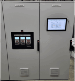 Two gray industrial control panels labeled SCP3409 and SCP3407. The left panel has three digital displays and buttons; the right panel has a touchscreen showing charts and data. Both have ventilation grilles at the bottom.
