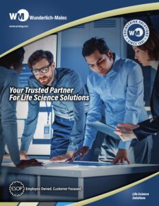 Three professionals in business attire collaborate over documents and a digital tablet at a workstation. Text reads “Your Trusted Partner For Life Science Solutions.” The scene highlights Wunderlich-Malec branding on the image.